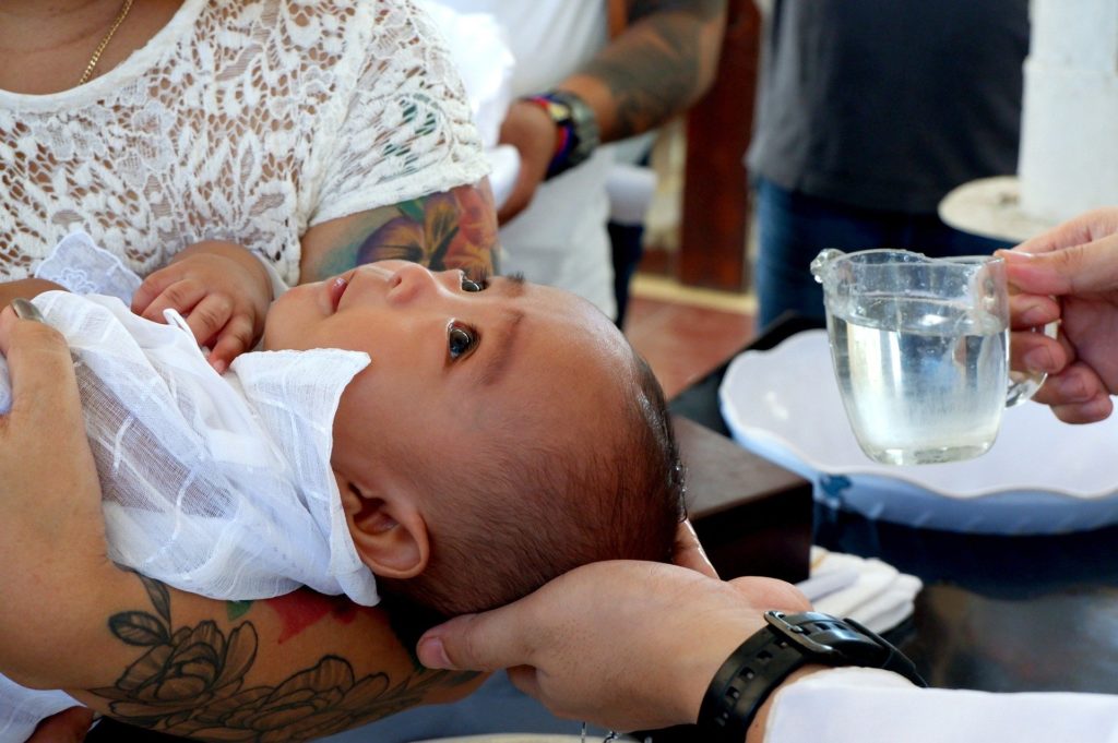 Photo of child being christened